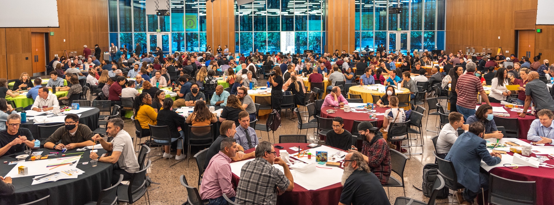 large room with round tables filled with people at Empower 2022