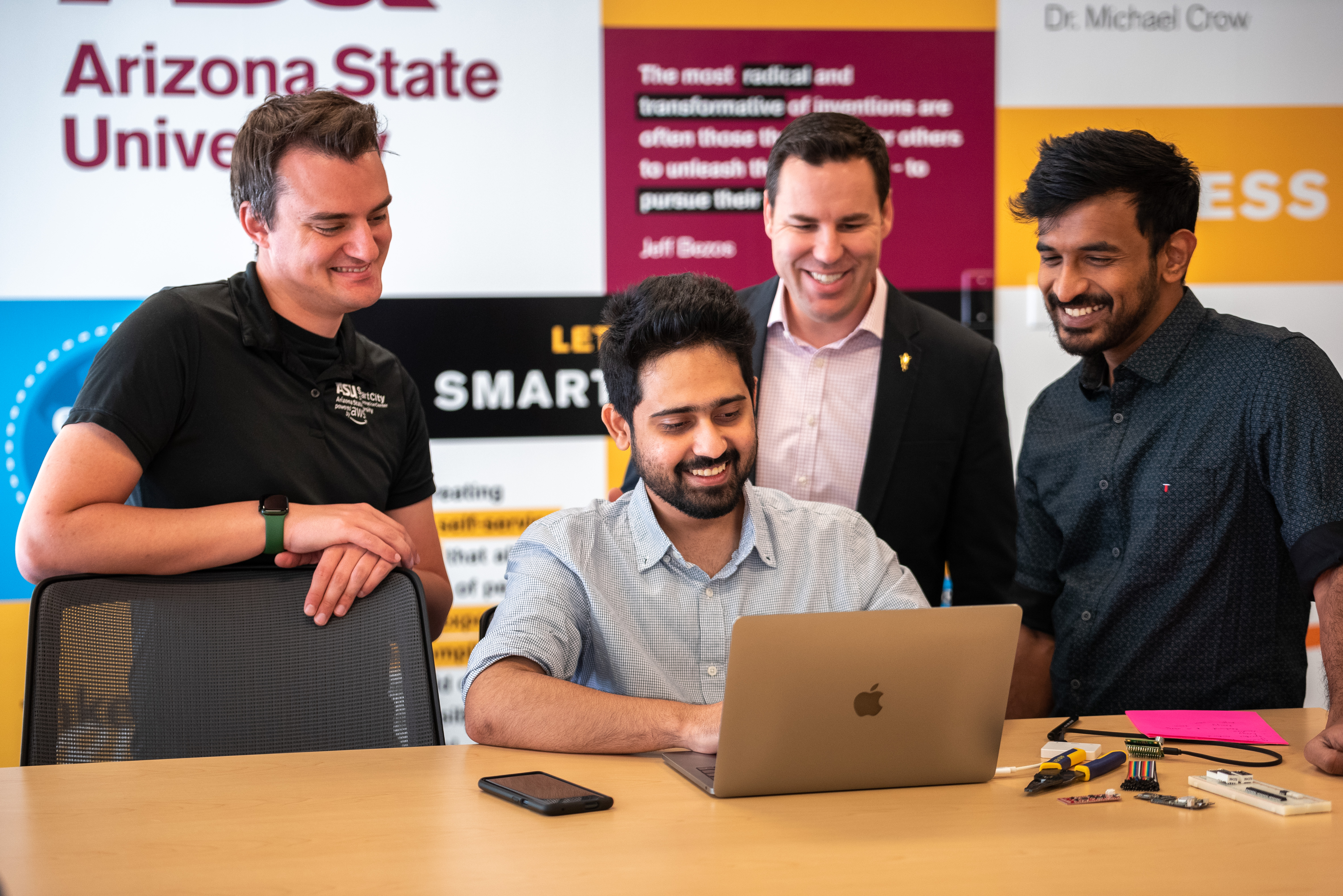 ASU students and interns at the Cloud Innovation Center working on a project with CIC Manager Ryan Hendrix. Photo by UTO's Mike Sanchez.